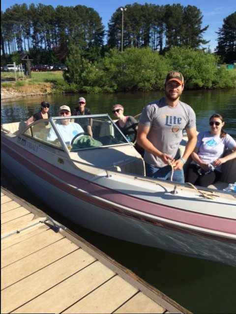 Bruce Andersen (seated behind wheel), a member of Lake Norman Covekeepers, takes a group of volunteers from Whole Foods out to remove trash from the lake.