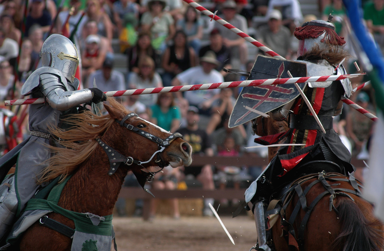 Actor Bill Burch, a.k.a. Sir William, left, shatters his lance on Jarrod Listiak a.k.a. Sir Phillipe a during the jousting performance in the desert arena at the Arizona Rennaissance Festival east of Phoenix. The wildly popular event celebrates the midieval times with a festival, artisans market, live entertainment and 1,000 actors in costume. The event, billed as the "greatest party since Camelot" runs for eight weekends beginning in February. (Rick D'Elia)