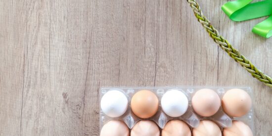 eggs on wood panel with necklace